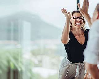 A group of people is having fun at a meeting.