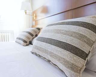 Close-up of striped cushions on a bed.